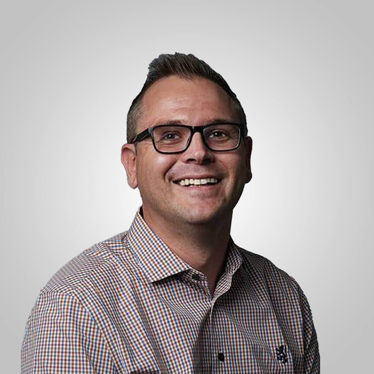 Professional headshot of a smiling businessman wearing glasses